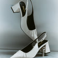 Women's white leather slingback block heel with ruched detailing and buckle fastening