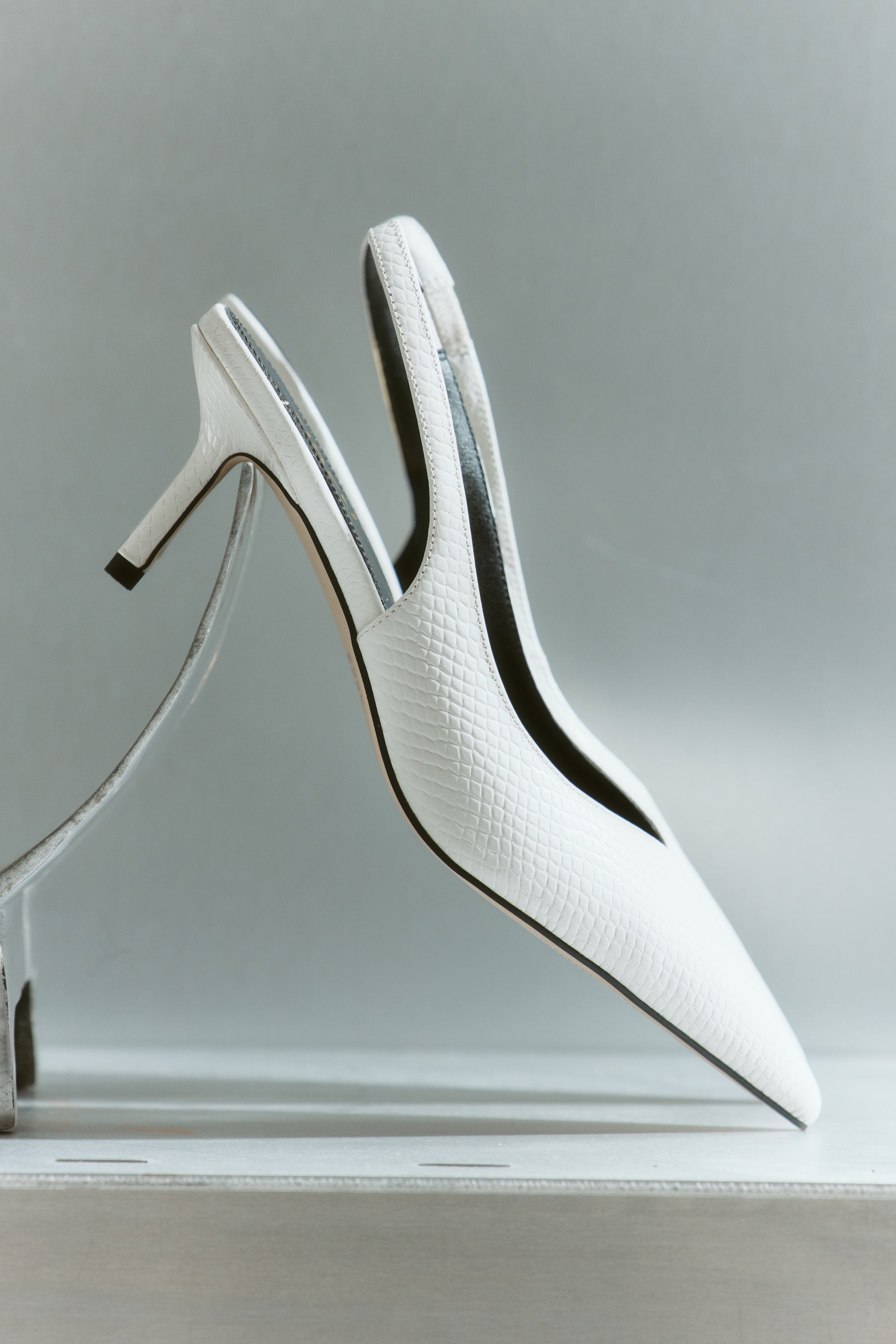 Women's slingback kitten heel in white croc leather with pointed toe and v shaped throat and elastic fastening